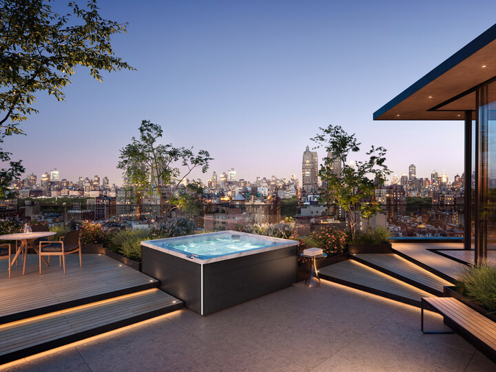 luxury hot tubs - the jacuzzi J-LXL on a patio with a cityscape in the background